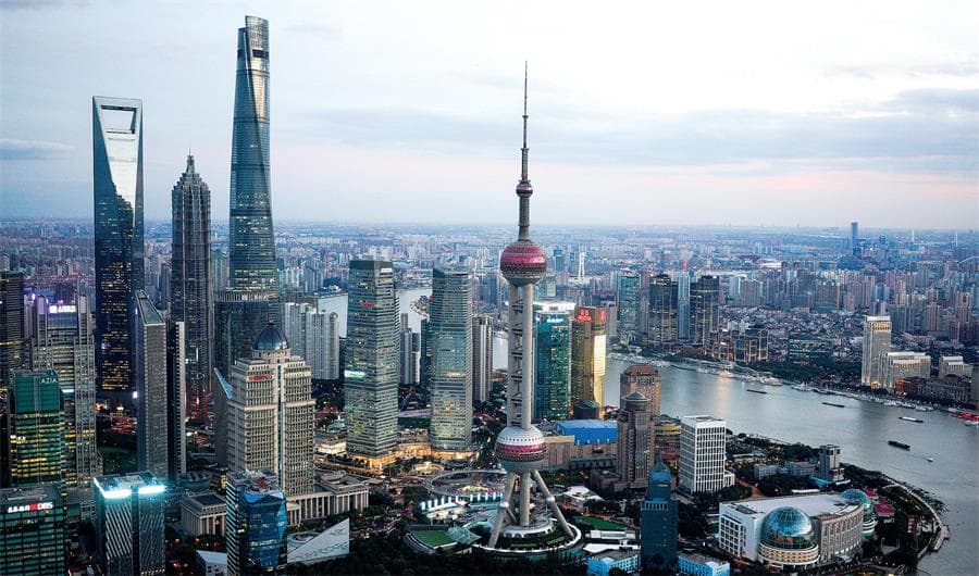 The Shanghai skyline at dusk with the Oriental Pearl Tower and the Pudong financial district