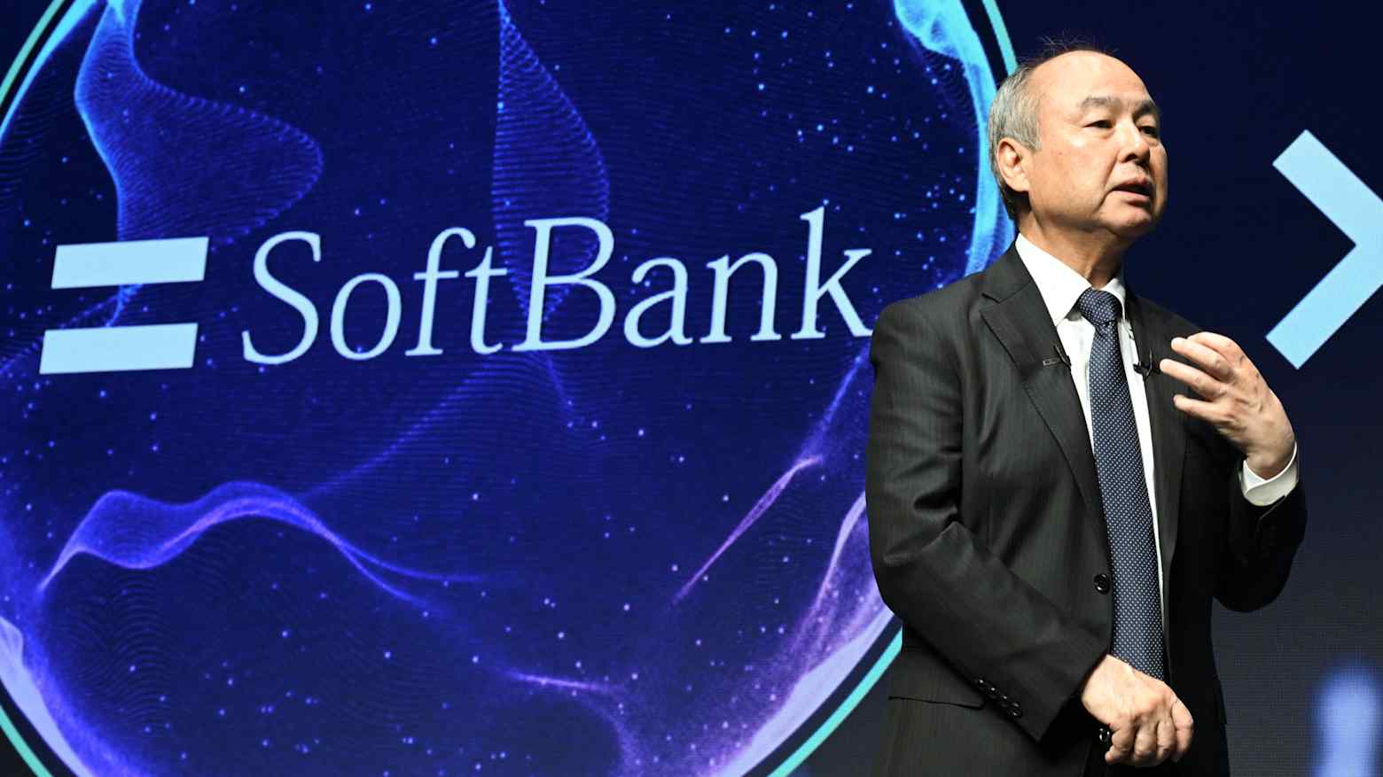 SoftBank chairman Masayoshi Son speaking in front of the SoftBank logo
