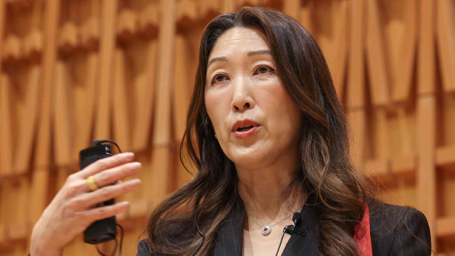 Takeda chief executive Julie Kim speaking to reporters