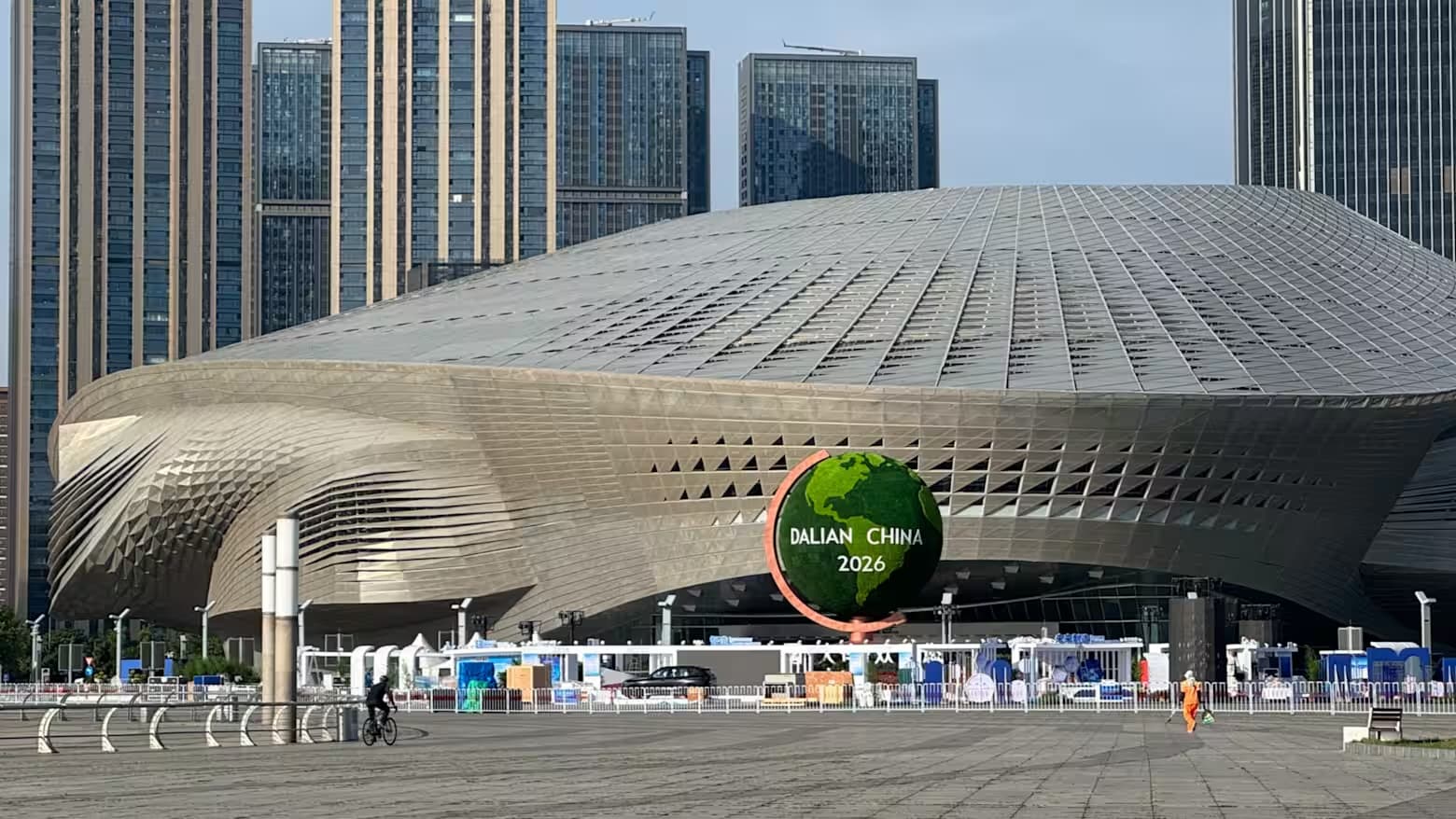 The Dalian International Conference Center, venue for the Summer Davos forum, with a Dalian China 2026 globe out front