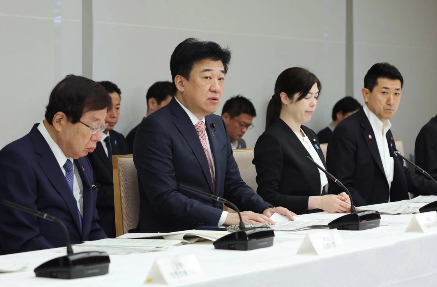 Japanese cabinet ministers seated at a government meeting on foreign nationals policy in Tokyo