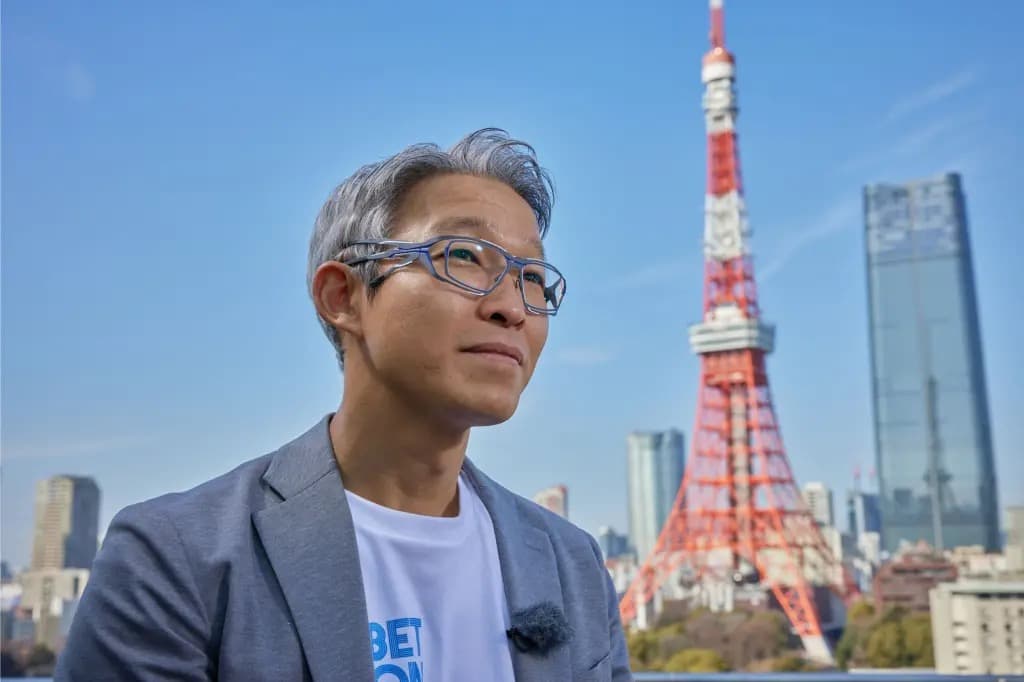 Indeed CEO Hisayuki Idekoba standing outdoors with Tokyo Tower in the background