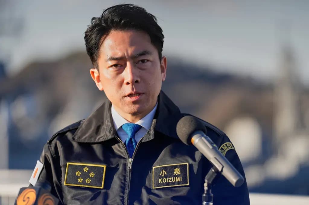 Japanese Defense Minister Shinjiro Koizumi speaking to reporters in uniform
