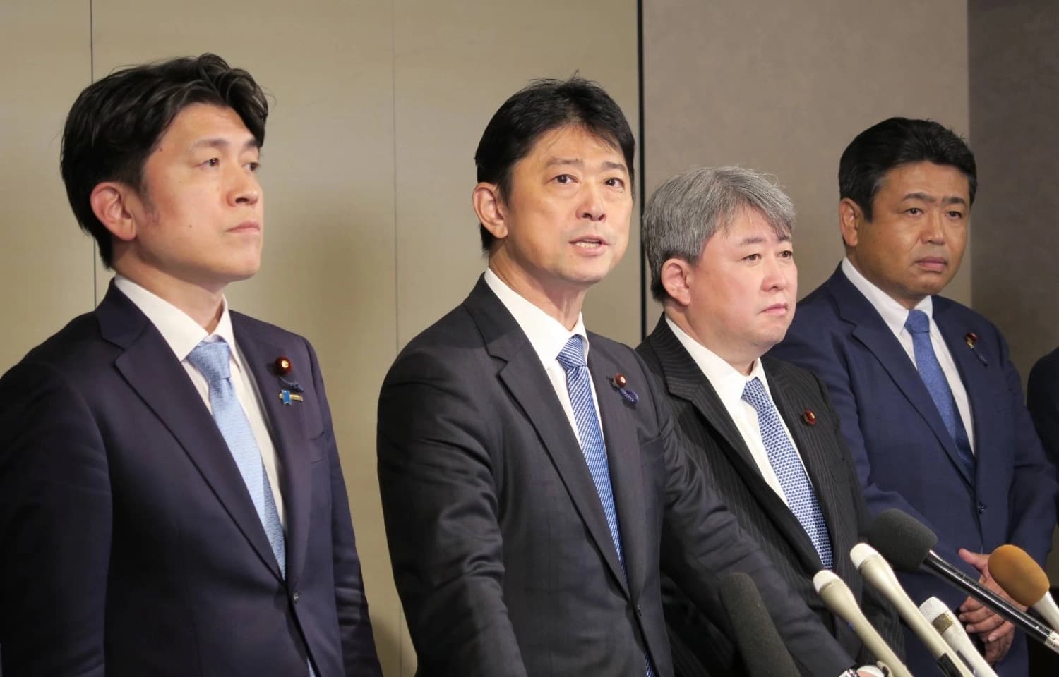 Japanese lawmakers speaking to reporters at a press conference in Tokyo