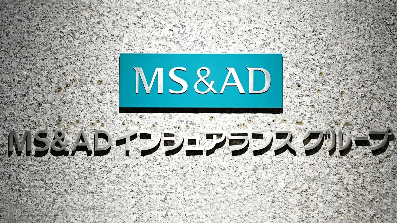 MS&AD Insurance Group signage mounted on a stone building facade