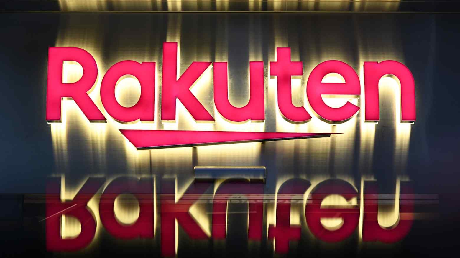 The Rakuten logo displayed on a sign, reflected on a polished surface