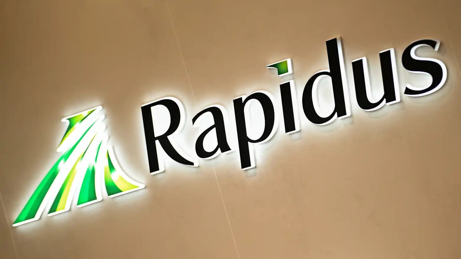 Illuminated Rapidus company signage on a wall