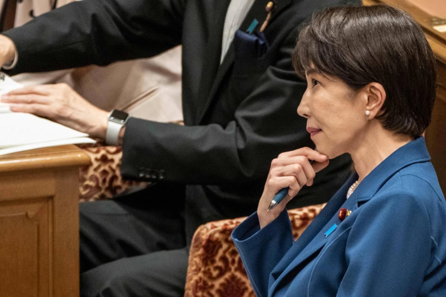 Japanese Prime Minister Sanae Takaichi listening during a parliamentary session
