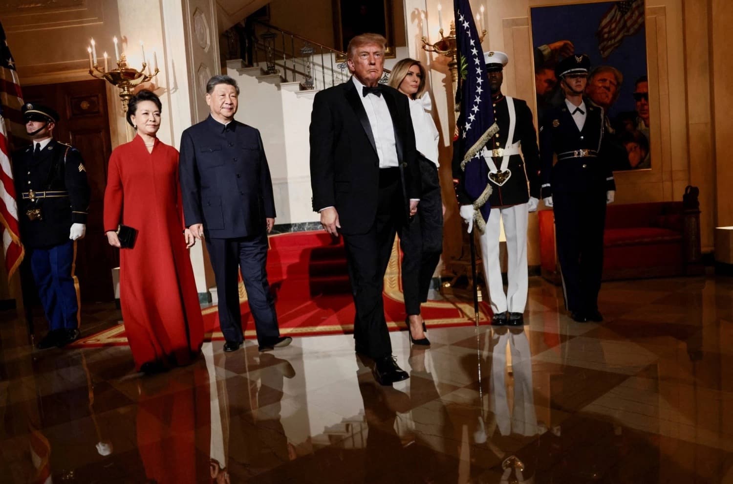 Donald Trump and Xi Jinping walking with their spouses through the White House during a state visit