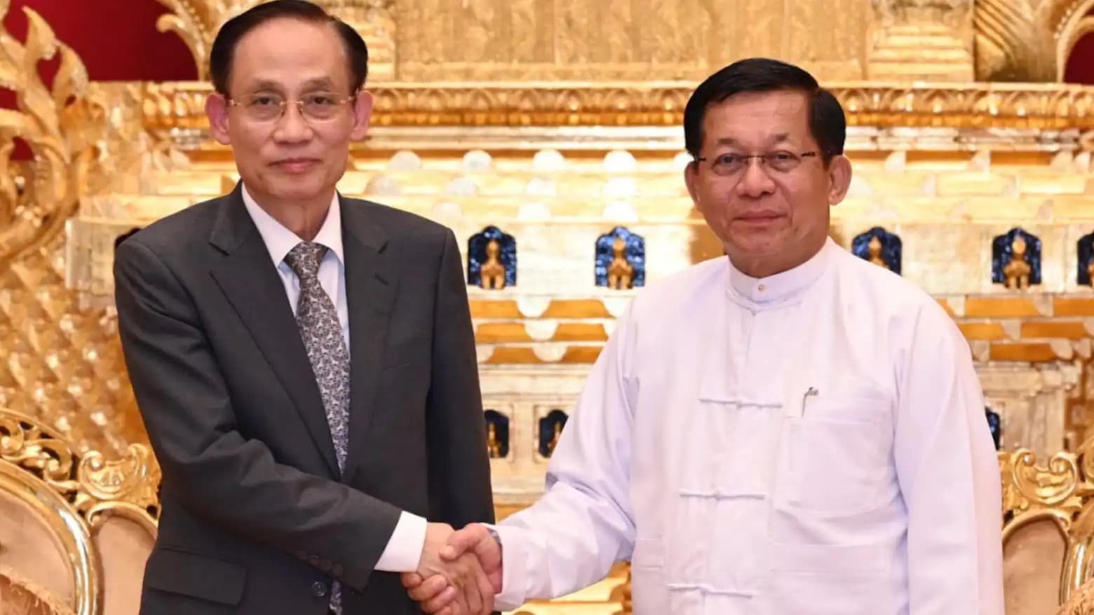 Vietnamese Foreign Minister Le Hoai Trung shakes hands with Myanmar President Min Aung Hlaing in Naypyidaw