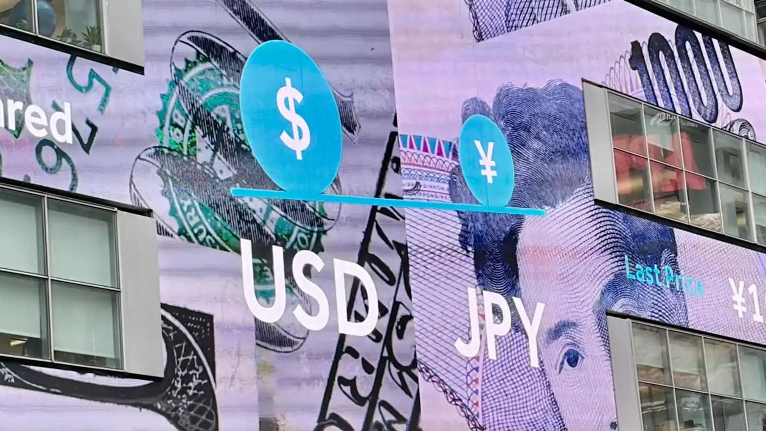 A digital billboard in Tokyo showing a balance scale between the US dollar and Japanese yen